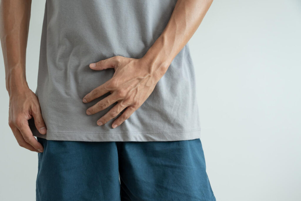 man holding bladder area