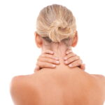 woman massaging sore neck